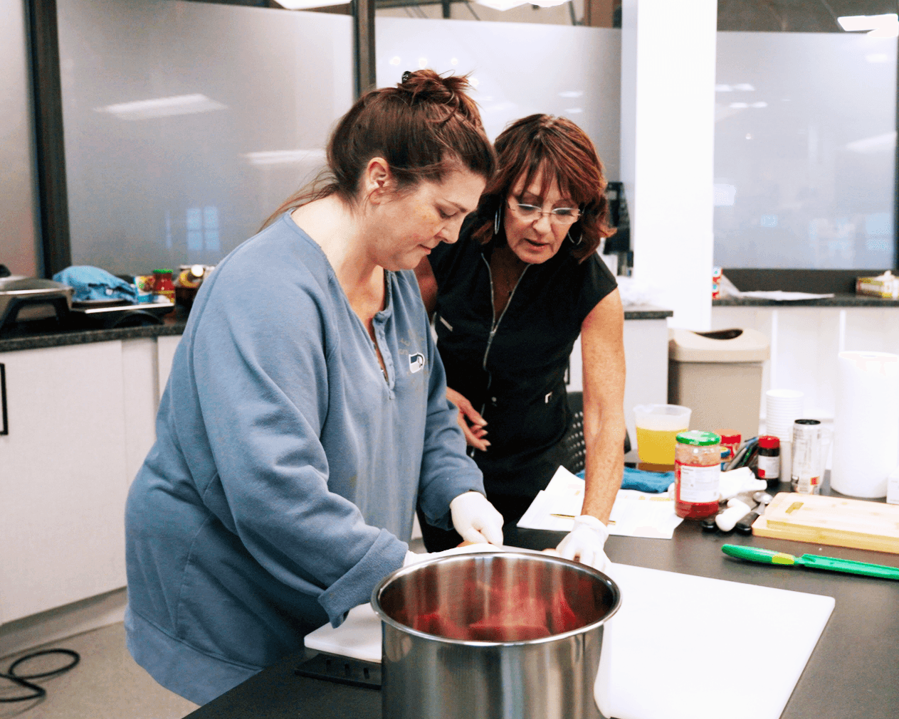 Two women cooking during Pathways to Prosperity program.